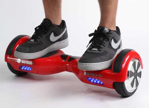 Red_self-balancing_two-wheeled_board_with_a_person_standing_on_it.png